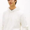 Hanorac cu glugă din velur jacquard cu logo cu steaguri pe toată suprafața Hanorac cu glugă din velur jacquard cu logo cu steaguri pe toată suprafața