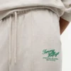 Pantaloni de trening din material froté cu logo script relaxat Pantaloni de trening din material froté cu logo script relaxat