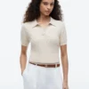 Polo cu mâneci scurte, tricotat cu model în relief Polo cu mâneci scurte, tricotat cu model în relief